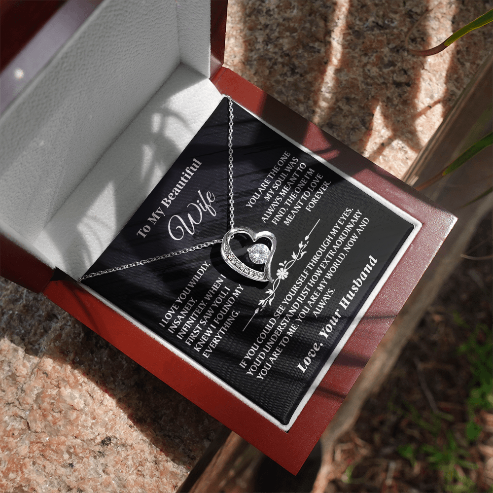 Silver Forever Love Necklace Gift Set - AA38 for wife shown in sunlight with romantic message card and elegant wooden box on stone surface.