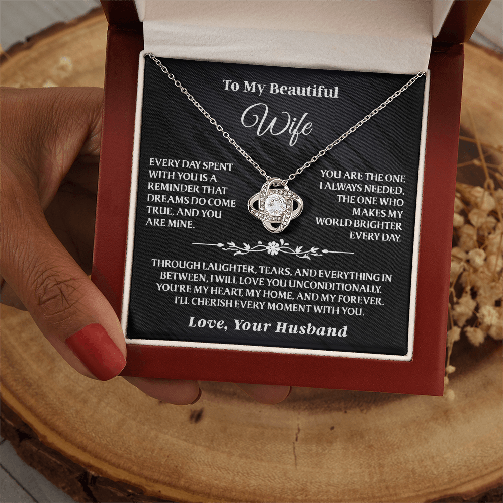 To My Beautiful Wife - Love Knot Gift Set - AA17 in cherry wood box held by hand, featuring silver necklace and touching message card.