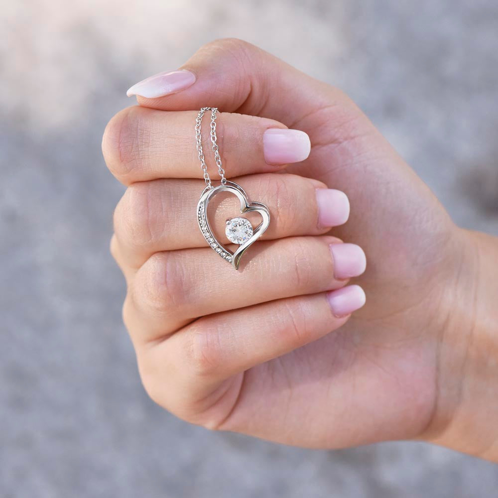 To My Wife – Forever Love Necklace Gift Set shown in hand, highlighting the silver heart pendant with central crystal, a meaningful jewelry gift.